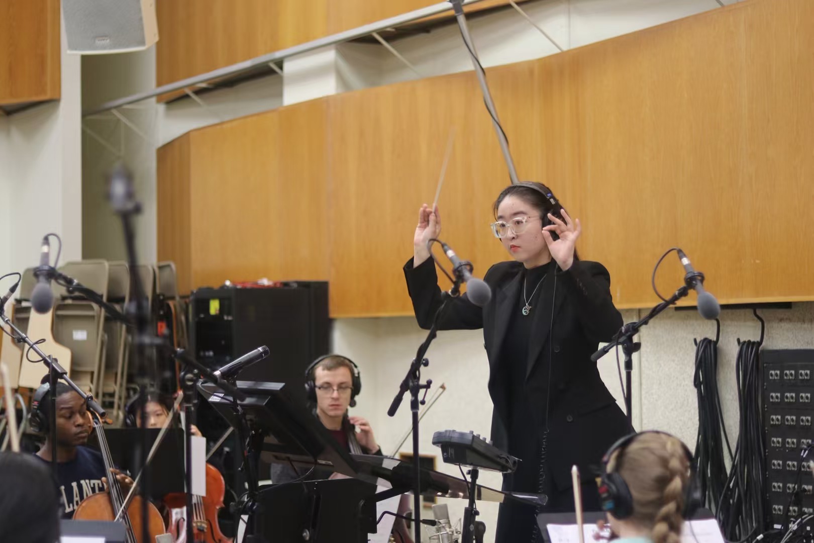 Leya Li conducting an orchestra recording session